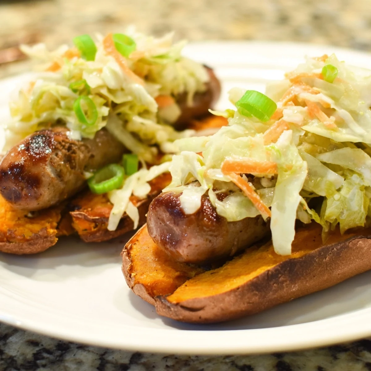 Tender grilled Sweet Potato Bratwursts layered on roasted sweet potatoes, topped with fresh sauerkraut slaw.