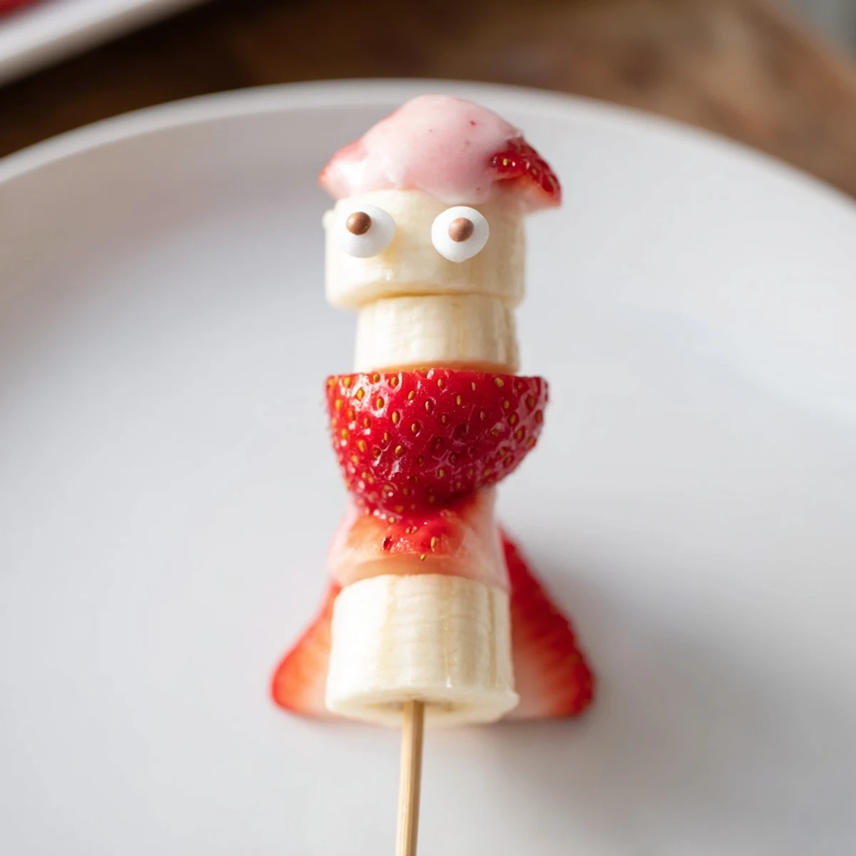 Strawberry Banana Santa Sticks arranged on a platter, a colorful and healthy festive snack for kids.