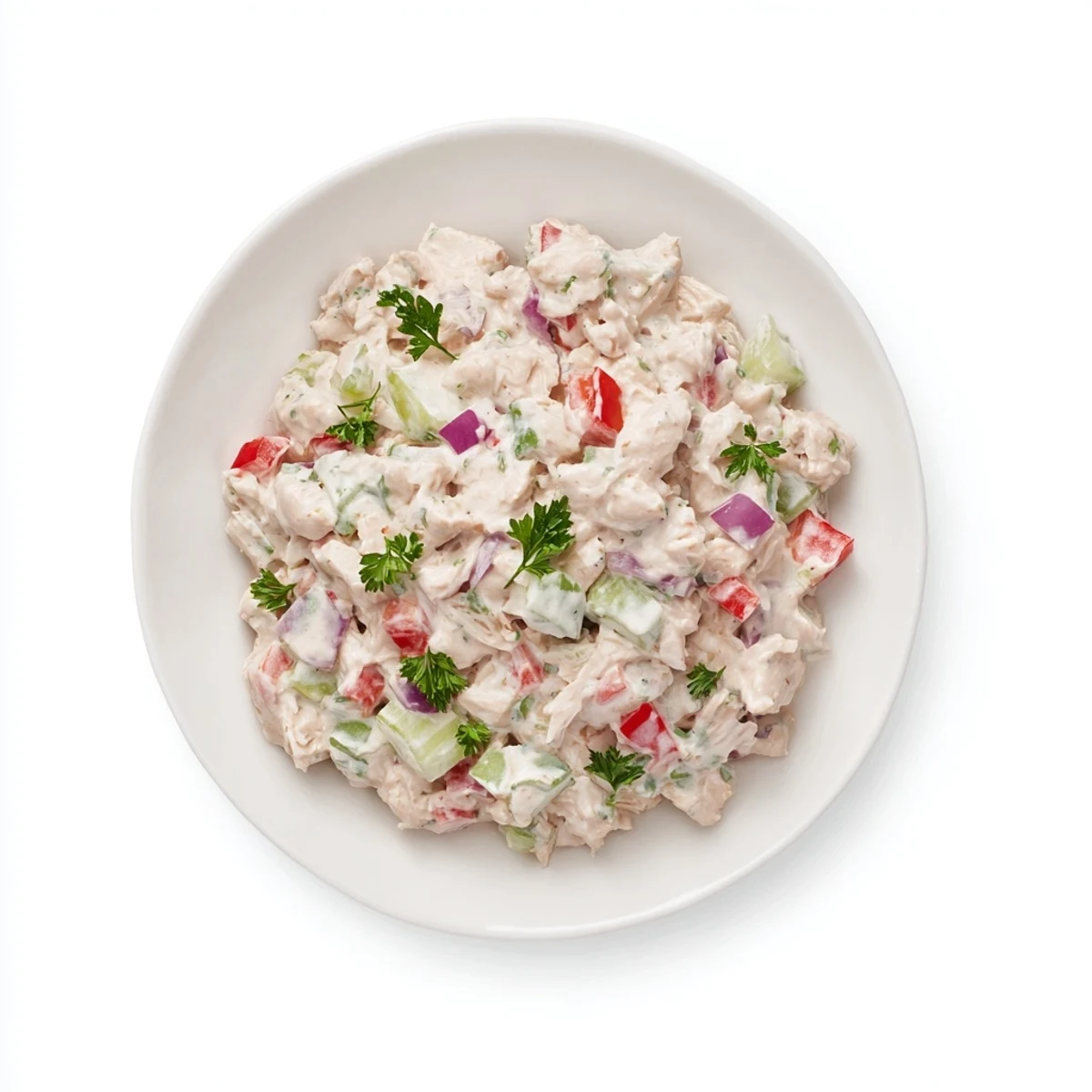 Homemade canned chicken salad, piled high with vegetables and sprinkled with fresh parsley.