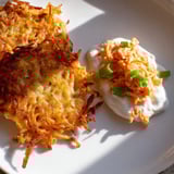 A stack of freshly fried Potato Pancakes with a creamy, spicy kimchi yogurt for dipping is visible.