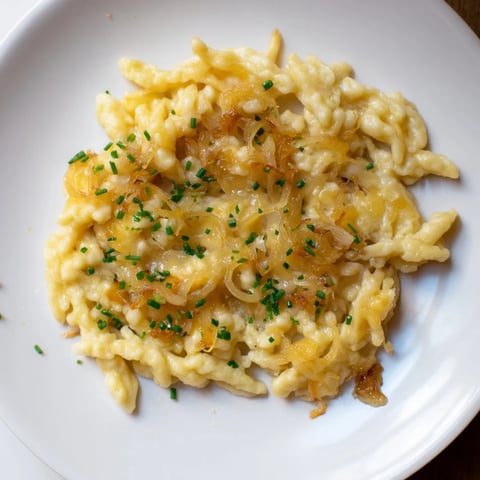 Golden, bubbly cheesy spaetzle skillet, a vegetarian comfort food classic, ready to serve!