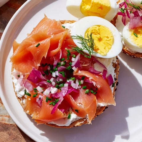 Vibrant Cranberry Sleigh Bagel Board, piled with bagels, smoked salmon, and fresh holiday fruit.