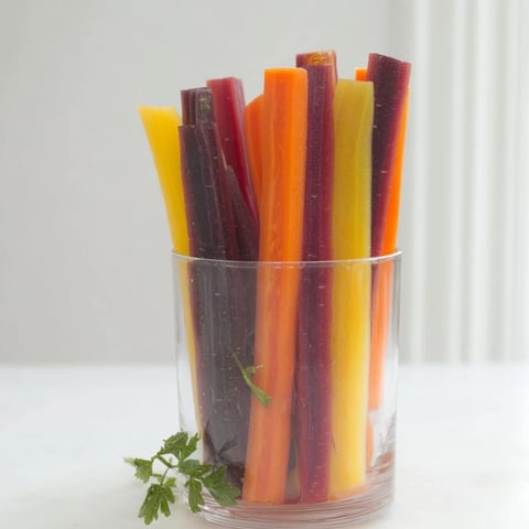 Colorful Simple Crudités: Rainbow carrot sticks stand upright in chilled glasses, a refreshing appetizer.