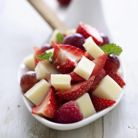 An eye-catching Candy Cane Stripe Fruit and Cheese arrangement, perfect for a festive appetizer spread.