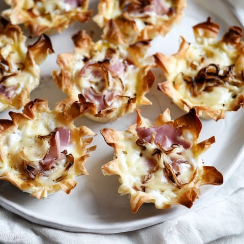 Holiday village board of mini quiches, a festive appetizer perfect for entertaining guests.