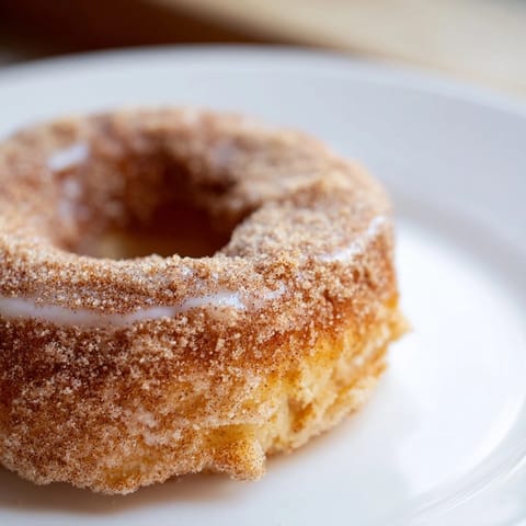 Close-up of freshly baked cinnamon-sugar donuts, ready to eat and delightfully sweet.