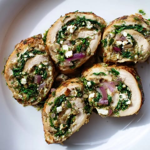 Savory Spinach Feta Stuffed Chicken with herbs, served with lemon juice, ready for a flavorful bite.