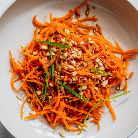 Close-up of a refreshing Spicy Carrot Salad with sesame seeds, ready to eat.
