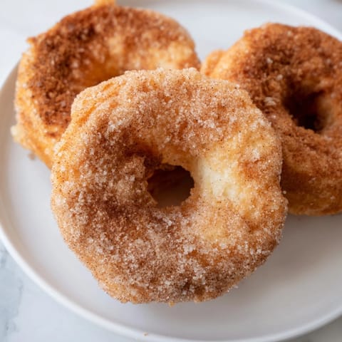 Close-up of fluffy 1-Minute Air Fryer Donuts, air-fried to perfection, a quick, easy dessert.