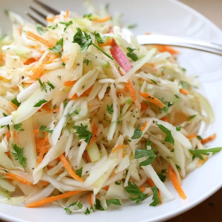Refreshing Sauerkraut and Apple Slaw served in a colorful bowl, perfect for picnics.  
