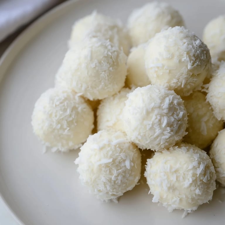 Creamy Marshmallow Snowball Dip Platter, a delightful dessert featuring coconut-covered snowballs and fresh fruit.
